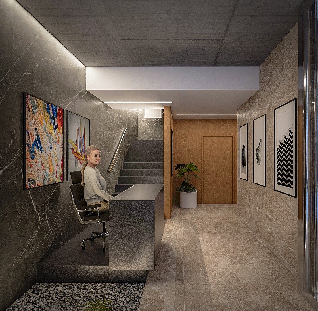 Lobby de Alpha Place Libertador con revestimiento en travertino y escultura Raging Bird by MIRA